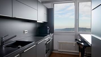 Comfort Condo | Private kitchen | Full-sized fridge, microwave, oven, stovetop