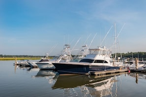 A marina with several yachts docked at the pier.