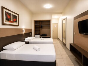 A hotel room with two beds, a wardrobe, a television, and a framed picture on the wall. - Athus Hotel by Bsb Inn (Brasília)
