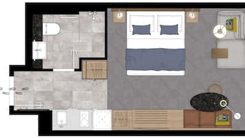 Quarto com cama, mesas de cabeceira e apoio para objetos pessoais.