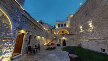 Relax in the serene courtyard, surrounded by historic architecture and comfortable seating areas.