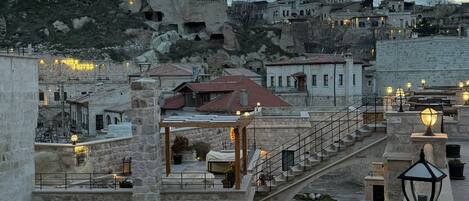 A coastal town with stone buildings, a sea view, and a stone bridge.