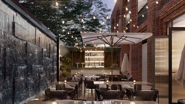 An outdoor dining area with tables and chairs, a bar with bottles and glasses, and a brick wall.