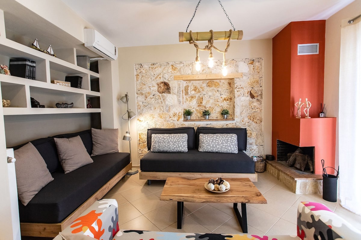 A modern living room with a sofa, coffee table, and shelves.