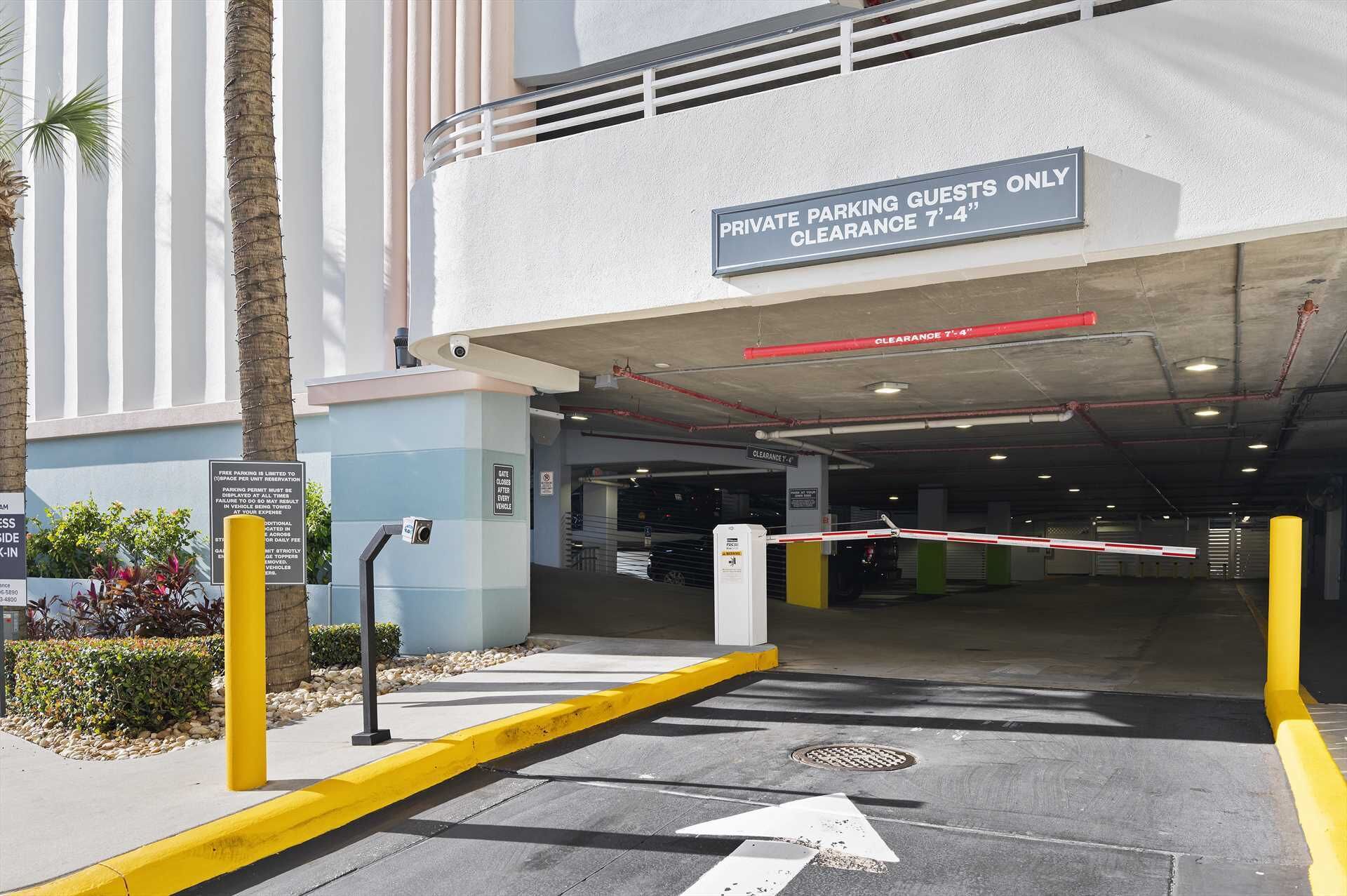 A private parking entrance with a clearance sign of 7'-4", a gated entrance, and a yellow curb.