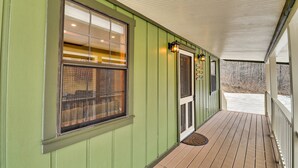 A covered porch with a green exterior, a wooden deck, and a door with a glass panel. - Want to REALLY get away? Round Bottom Roost. Secluded. Close to everything. (Mountain View)