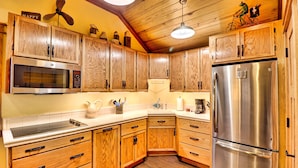 A kitchen with wooden cabinets, a stainless steel refrigerator, and a microwave. - Want to REALLY get away? Round Bottom Roost. Secluded. Close to everything. (Mountain View)