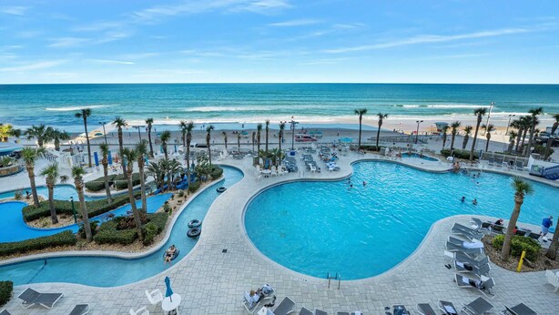 A resort pool with a view of the beach and ocean. - Luxury 5th Floor 3 BR Condo Direct Oceanfront Wyndham Ocean Walk Resort Daytona Beach | 504 (Daytona Beach)