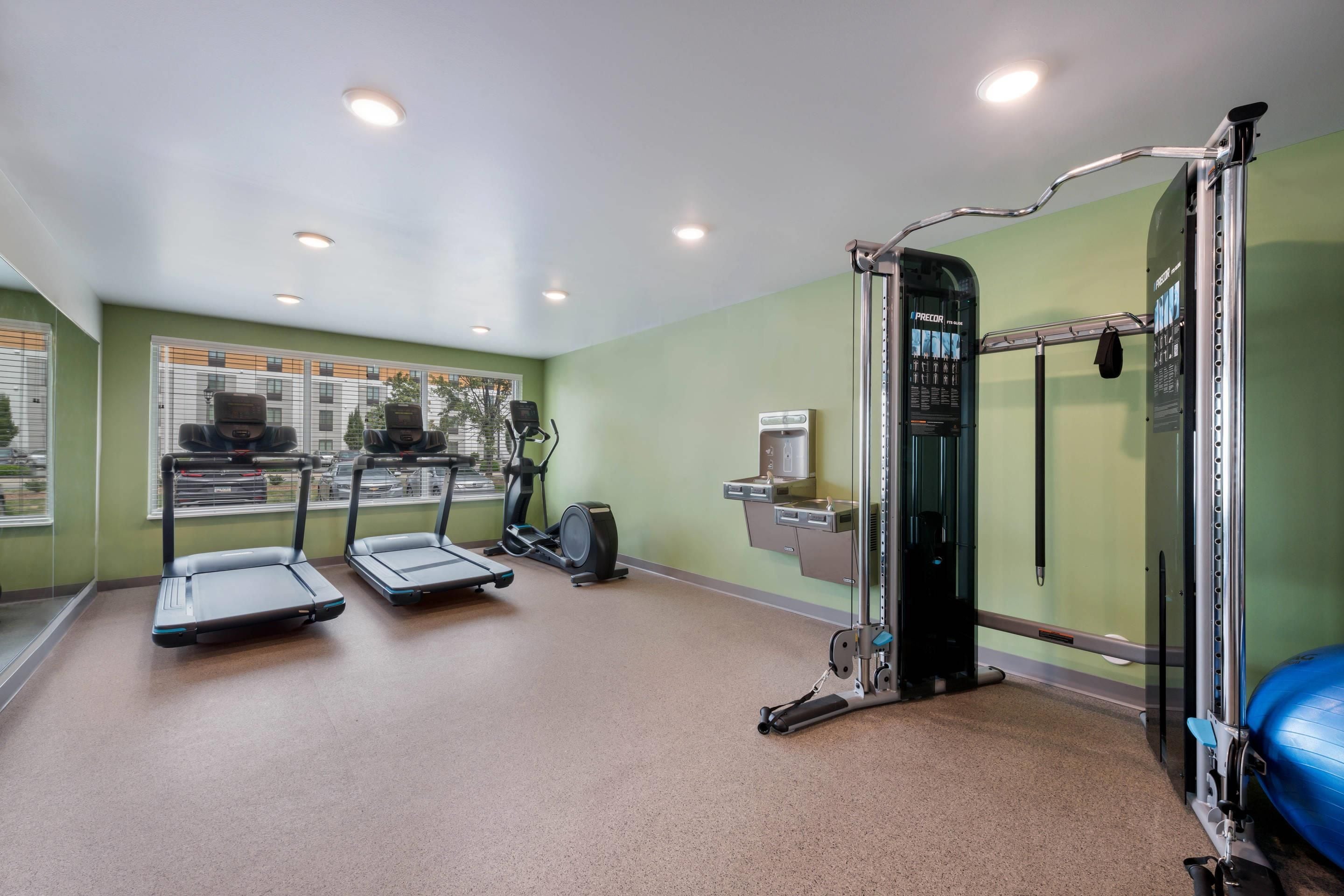 A gym with treadmills, a stationary bike, and a weight machine.