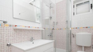 A bathroom with a white sink, a glass shower enclosure, and a toilet. - Apartments Antonio - Studio with Balcony (2+1) - 5 (Tucepi)