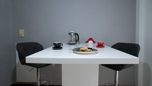 A white table with a plate of cookies, a coffee pot, and two cups. - Modern design - Lux 1 B Apart. -15 m. from Acropolis! (Athina)