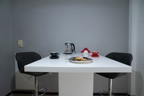 A white table with a plate of cookies, a coffee pot, and two cups. - Modern design - Lux 1 B Apart. -15 m. from Acropolis! (Athina)