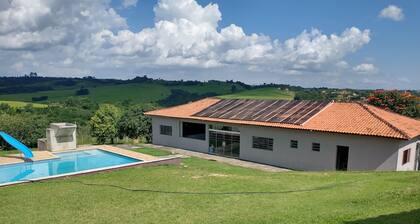 Huge farm with pool, game room and lots of green.