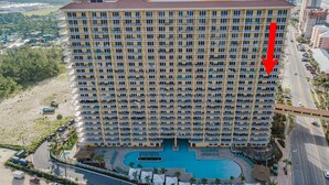 A high-rise hotel with multiple balconies and a swimming pool. - Fall Dates Available! Book Now! Great Location! (Panama City Beach)