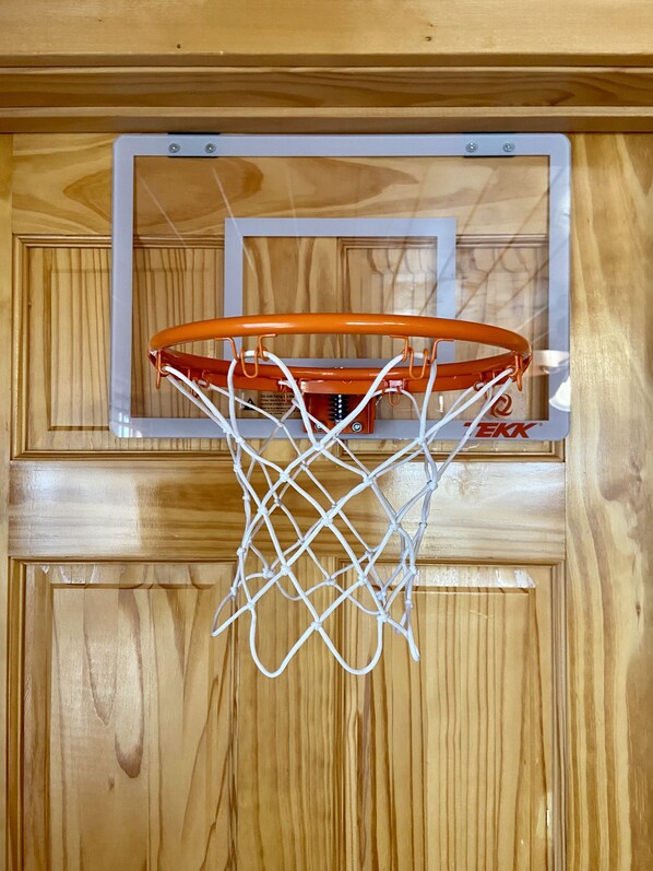 A basketball hoop mounted on a wooden wall.
