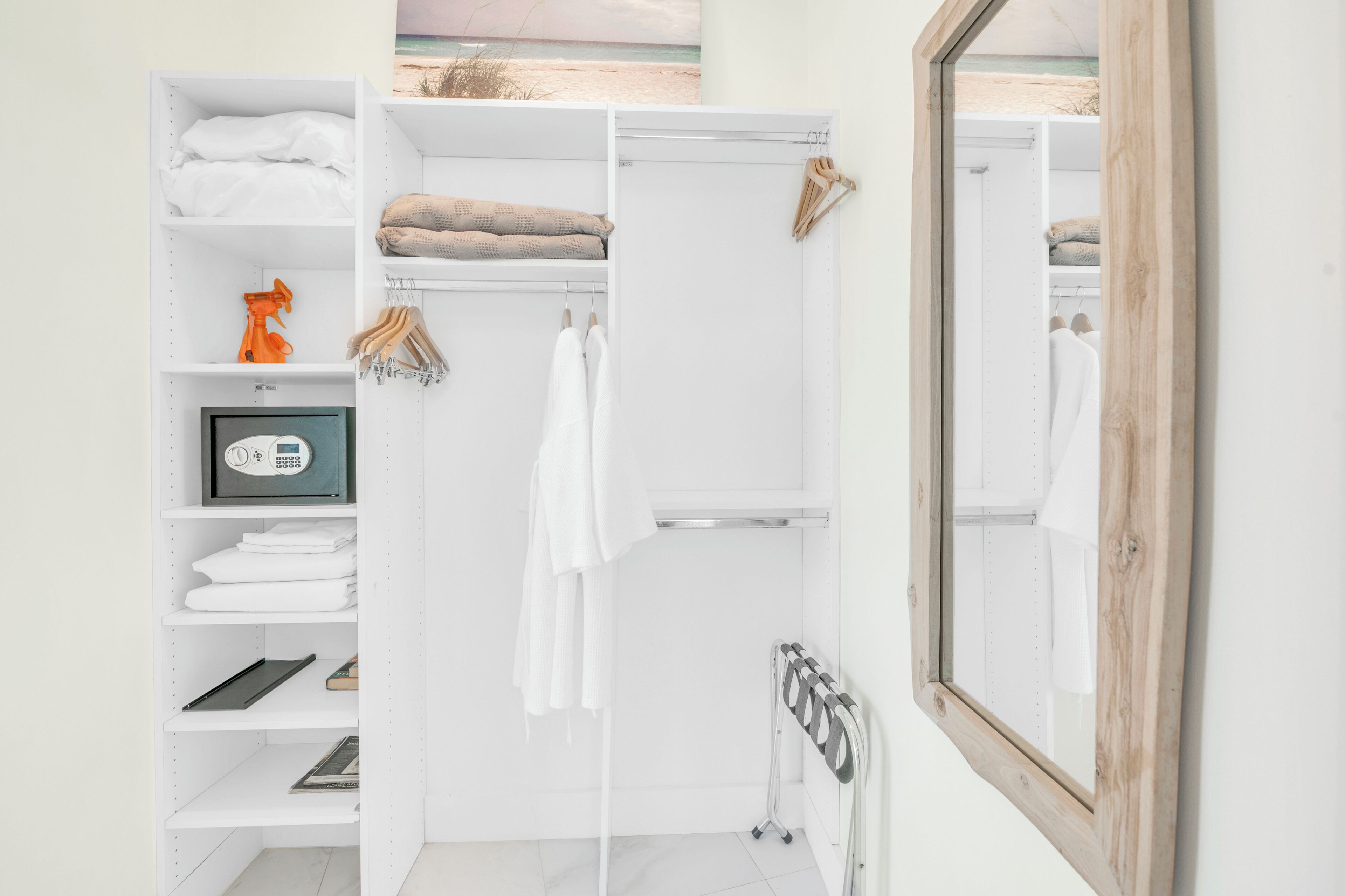 A modern bathroom with a white vanity, a shower, and a large mirror.