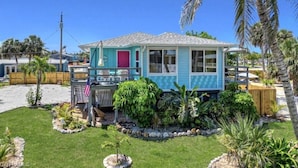 A single-story house with a porch, a small garden, and a palm tree. - 120 Bay Mar Dr (Fort Myers Beach)