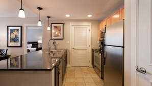 A modern kitchen with a central island, stainless steel appliances, and pendant lighting. - Fraser Crossing/Founders Pointe, Condo | 2 Bedroom (Value-Rated Condo 4281) (Winter Park)