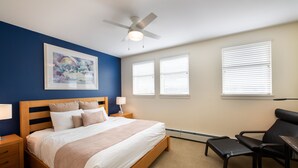 A bedroom with a bed, a desk, a chair, a ceiling fan, and two windows with blinds. - Fraser Crossing/Founders Pointe, Condo , Ski Slope View (Premium-Rated Condo 4340) (Winter Park)