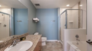 A modern bathroom with a granite countertop sink, a glass-enclosed shower, and a toilet. - Fraser Crossing/Founder Pointe, Townhome style Condo | Gondola Acess (Value-Rated Condo 3229) (Winter Park)