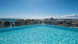 A clear blue pool with a view of a coastal cityscape. - Estepona Roof Top View 4 by Interhome (Estepona)