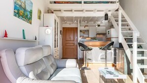 A modern apartment with a loft bedroom, a dining area, and a kitchen. - Les Reflets by Interhome (Saint Cyprien)