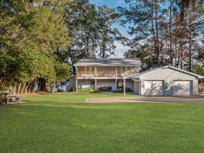 A two-story house with a balcony and a garage. - Talquin Time: Lakefront - Dock - Pool Table (Quincy)