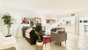 A modern living room with a sofa, armchairs, a coffee table, and a dining area. - BIG DISCOUNTS ! Fabulous DOWNTOWN Palm Springs! Gorgeous Mid Century. BEST area! (Palm Springs)