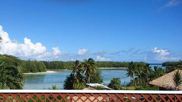 Enjoy a serene beach setting with ocean views and lush greenery.