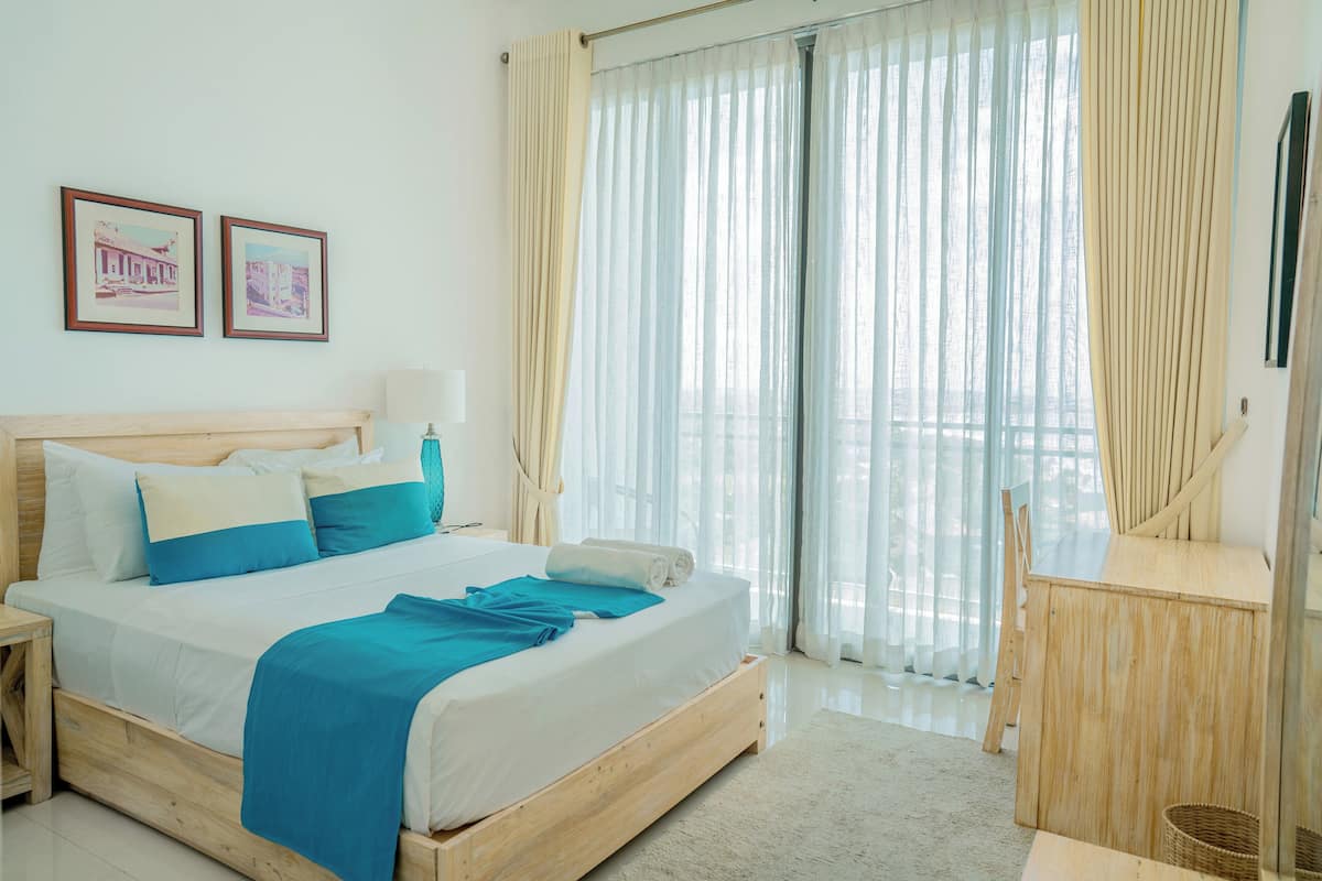 Deluxe Apartment, 2 Bedrooms, Kitchen, Partial Sea View | 2 bedrooms, individually decorated, individually furnished, desk