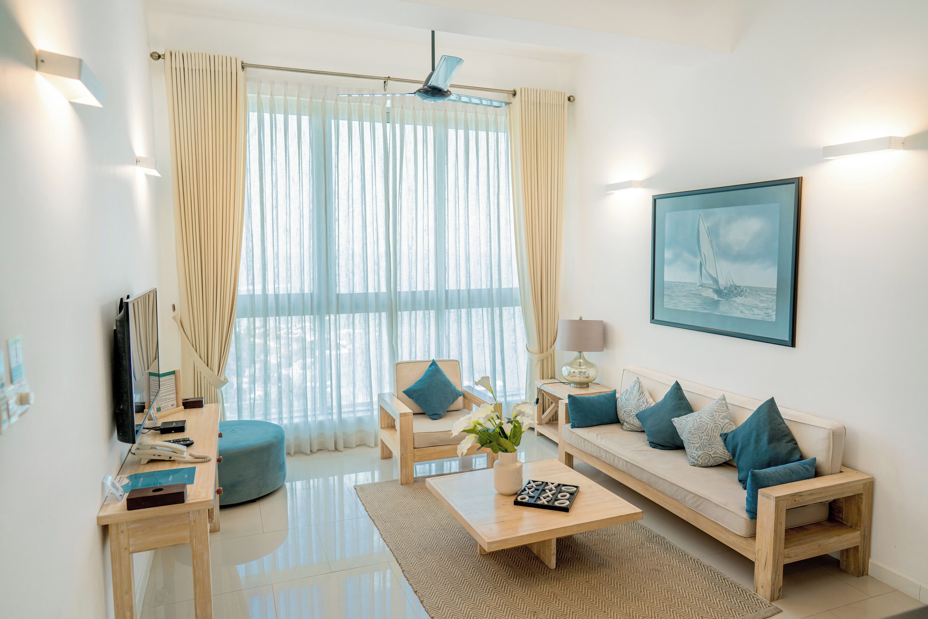 A modern living room with a sofa, coffee table, and a television.
