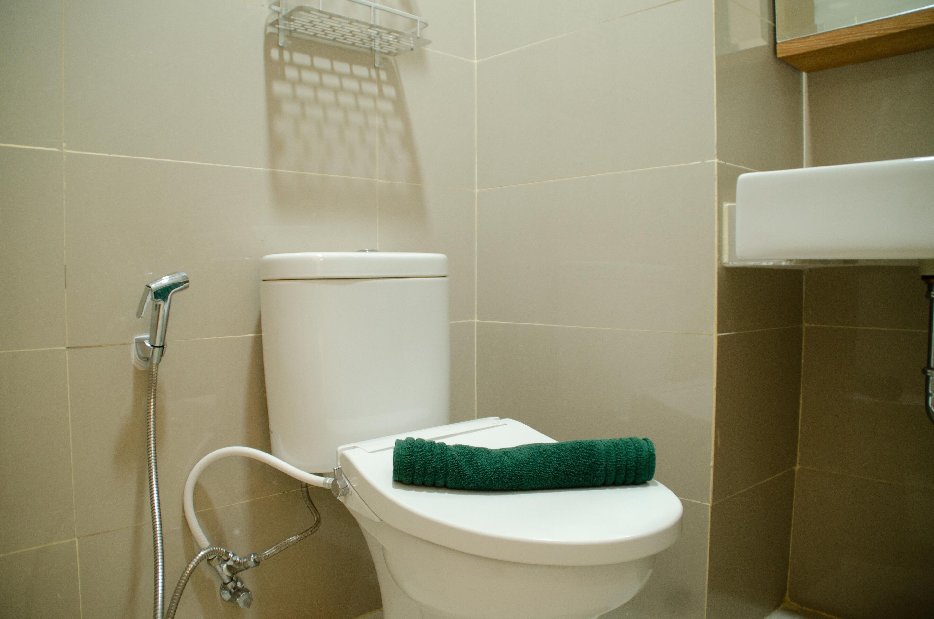 A bathroom with a toilet, a shower, and a sink.