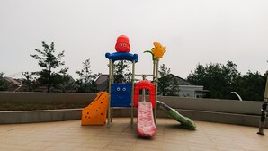 A playground with slides and climbing structures. - Comfy Studio At Amazana Serpong Apartment (South Tangerang)