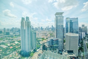 A cityscape with modern high-rise buildings, including a prominent 'PRIDENTIAL' building, and a mix of residential and commercial structures.