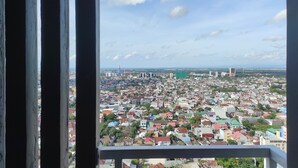 A cityscape viewed from a high vantage point, likely from a balcony or window. - Convenient Studio At Vida View Makassar (Makassar)