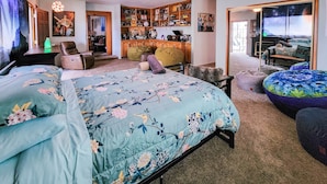 A bedroom with a bed, a desk, a chair, and a bookshelf. - Ultimate relaxation on 4+ acres, hot tub, projector/game room, BBQ, stars, moon (Yucca Valley)
