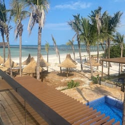 On the beach, white sand, sun loungers, beach umbrellas