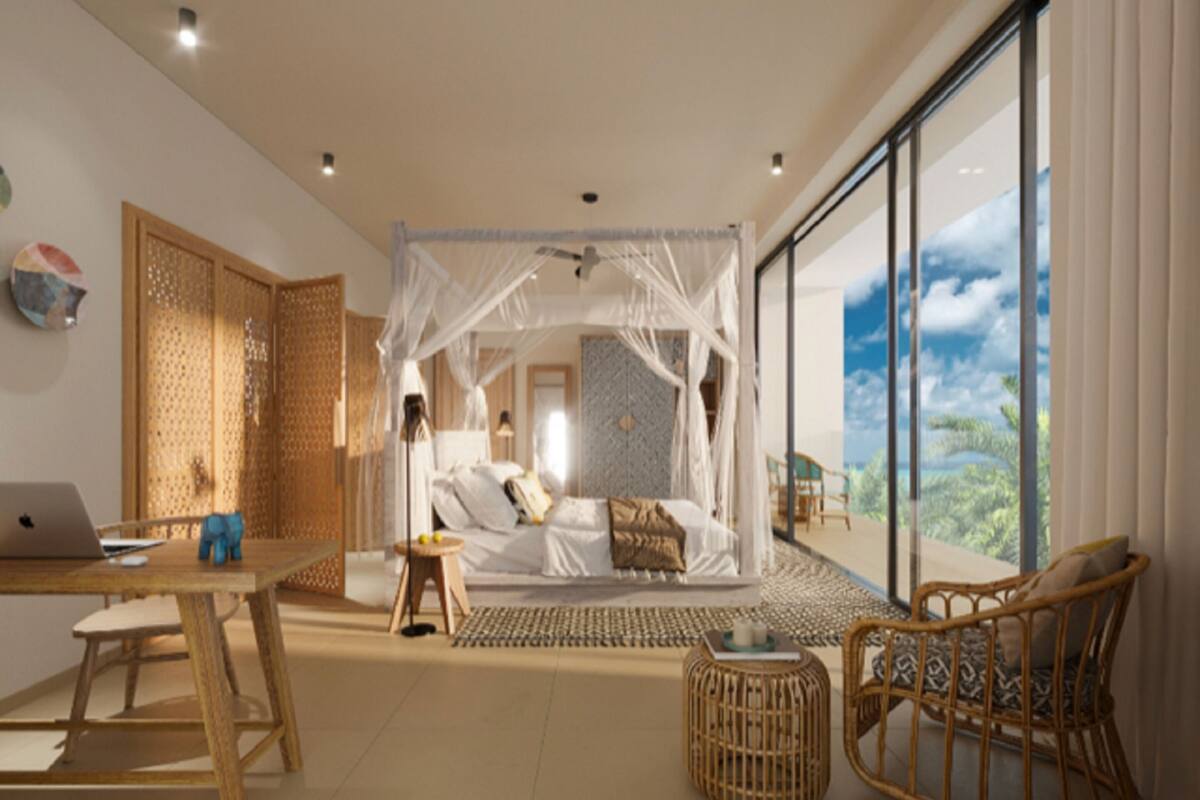 A modern bedroom with a canopy bed, a laptop on a desk, and a view of the outdoors.