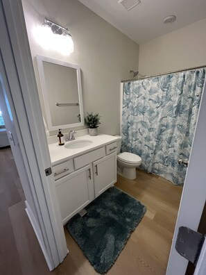 Combined shower/bathtub, towels, soap, toilet paper