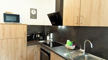 Comfort Apartment | Private kitchen | Full-sized fridge, microwave, oven, stovetop