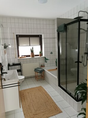 Bathtub, hair dryer, towels, soap