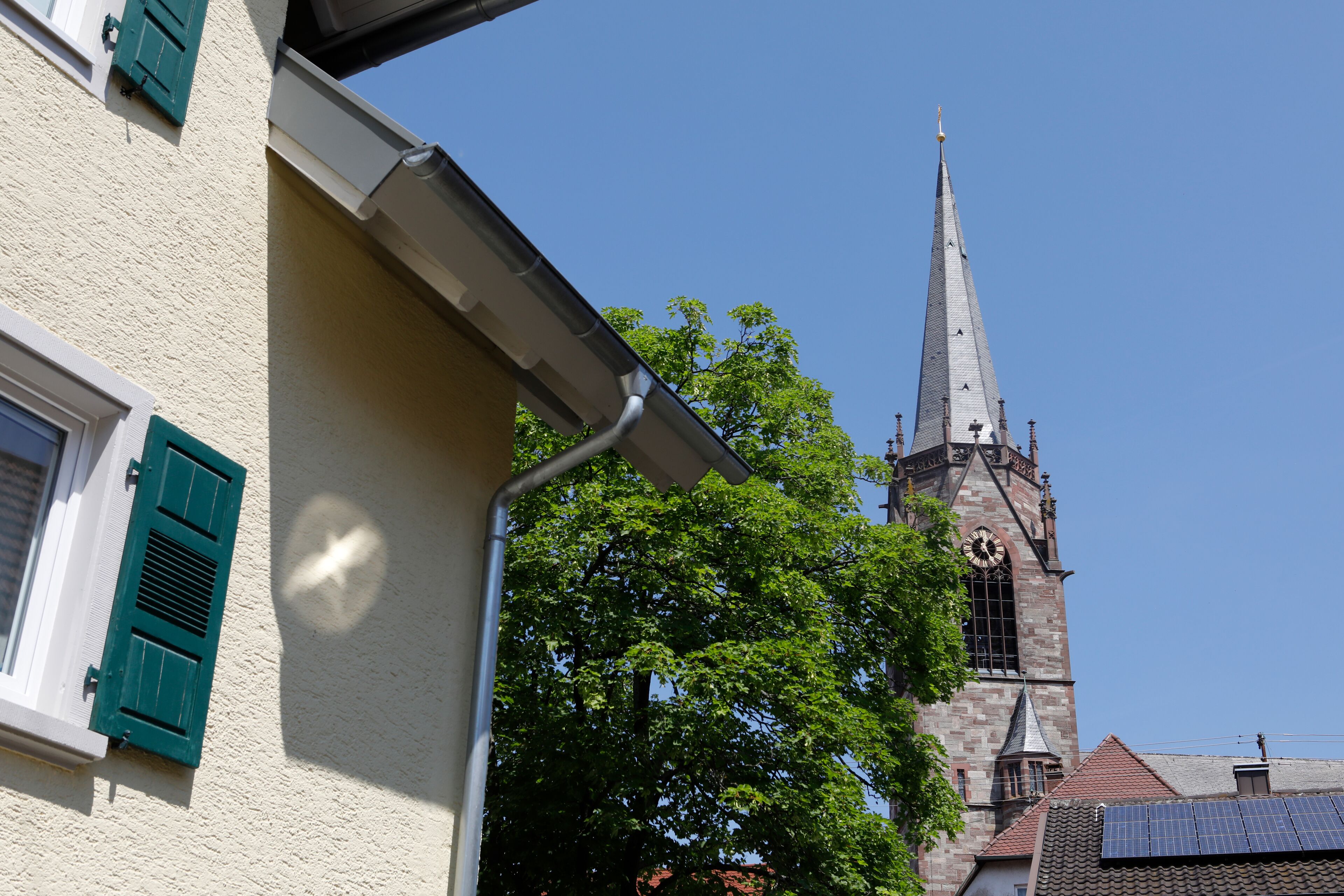 A church with a tall spire and a clock tower.