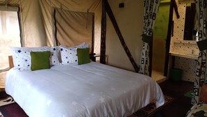 A tent-style room with a bed, curtains, and a mirror. - Mathioya River Lodge (Gacharageini)