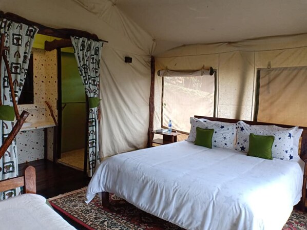 A tent-style room with a bed, curtains, and a window.