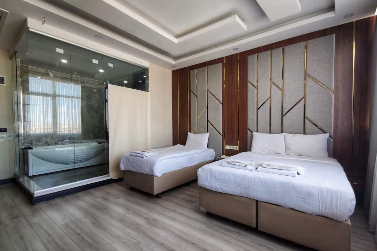 Deluxe Room, Hot Tub | Iron/ironing board, WiFi (free), bed sheets