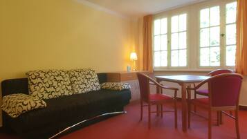 Classic Suite | Living area | 50-cm flat-screen TV with cable channels, TV, foosball