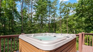 A hot tub on a wooden deck surrounded by a forest. - Hot Tub, Mirror Lake Access, Log Cabin - Hawks Terrace by Carolina Properties (Lake Lure)