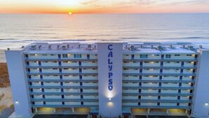 A hotel with a central tower labeled "CALYPSO" and multiple balconies. - Newly renovated 2 bedroom, 2 bath condo with beautiful views of the ocean! (Ocean City)
