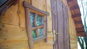 A wooden cabin with a window and a door.