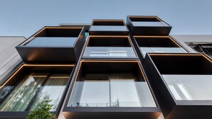 A modern building with multiple rectangular balconies and large windows. - Neoma  (Athens)